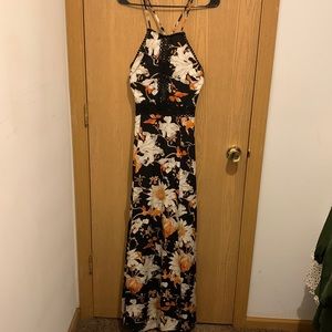 Black floral open back maxi dress with cutout detail through center and waist